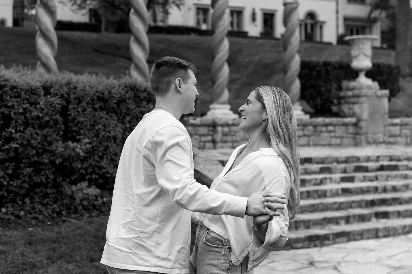 Sydney and Trenton facing each other on the lawn, the mansion rising behind them.
