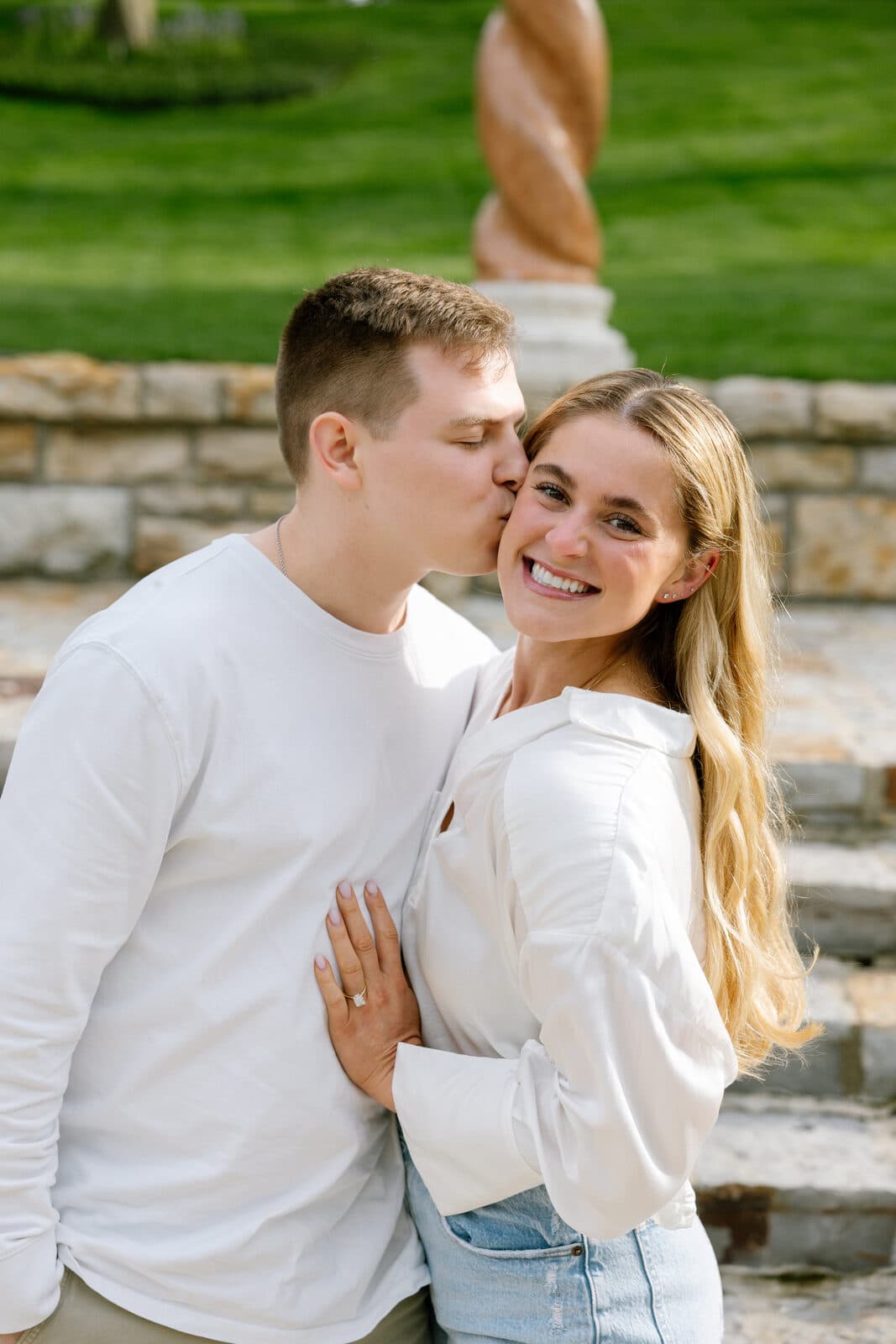 Trenton kissing Sydney on the cheek as she smiles.